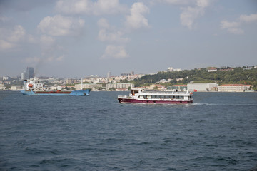 Fototapeta na wymiar Commercial and passenger ships passing through Bosphorus, Istanbul, Turkey. 