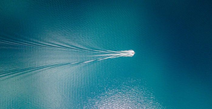 Drone view of a boat sailing across the blue clear waters of lake Tahoe California