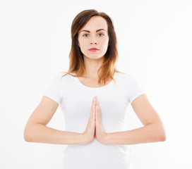Close-up of hands of beautiful woman, girl in white tshirt , meditating indoors, focus on arms in...