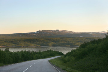 Panoramic road, among mountains and lakes in Lappland, north Sweden midninght sun