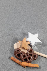 Cinnamon sticks beside wooden spoon and christmas decoration as a sign for christmas cookies