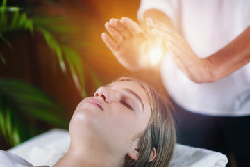 Close Up Of A Relaxed Young Woman Having Reiki Healing Treatment