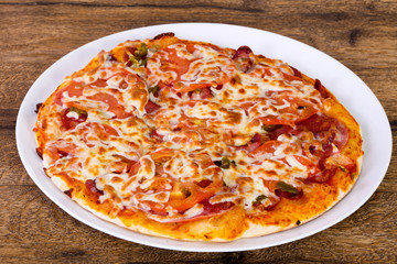 Pizza with sausages and tomato