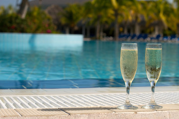 Champagne Glasses On The Side Of A Swimming Pool