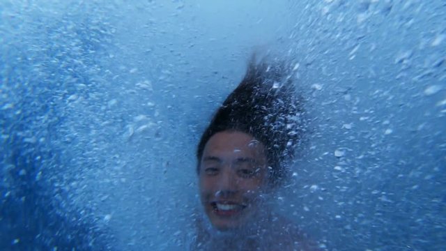 POV, man does backflip into ocean at sunset