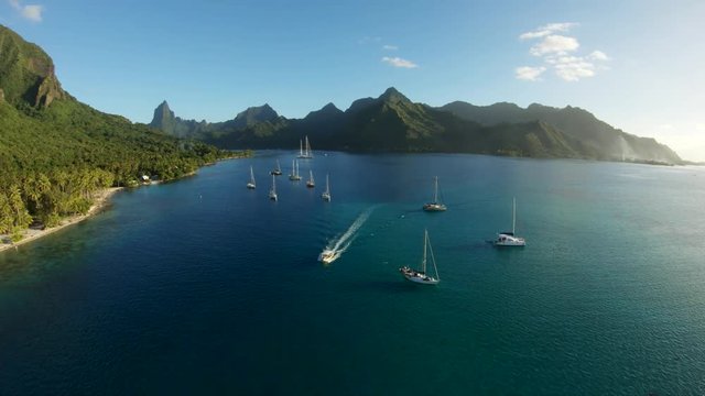 Slow motion, boat travels past Tahiti coast