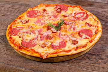 Pizza with ham and sausages