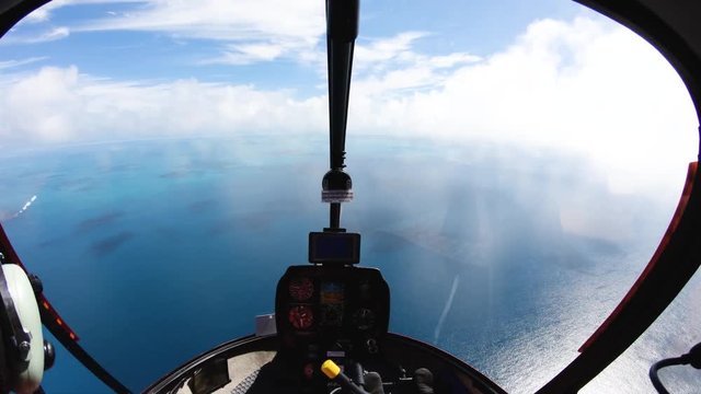 POV, inside helicopter cockpit over ocean
