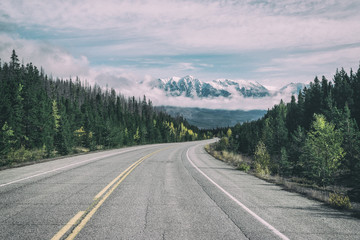 Empty highway heading up to mountains,Alberta,Canada