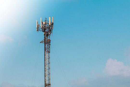 Mobile phone transmitter pole on blue sky with copy space for text.