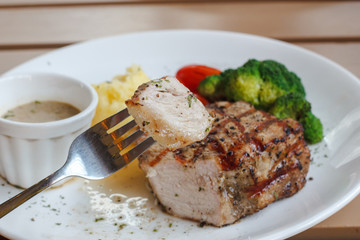 Enjoy eating bite Of Juicy Steak with Fork and blur background