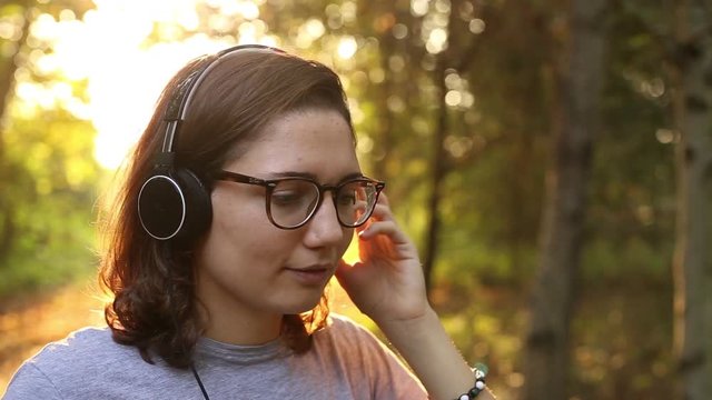 ragazza ascolta musica con le cuffie in un bosco