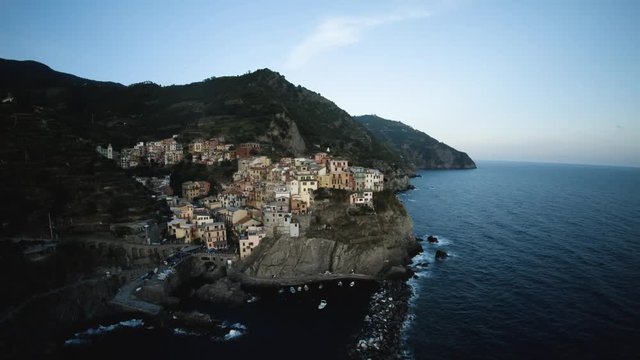 Town on coastal cliffs in Italy, wide aerial