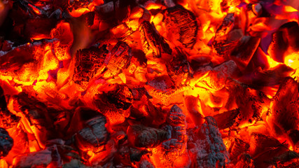 Background of burning hot coals, actively smoldering embers of fire