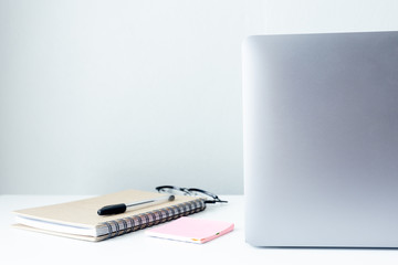 Laptop on white table blurred background