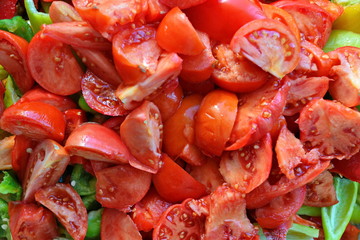 Fresh Chopped lettuce slices of red ripe tomato with pulp on green sweet pepper for salad