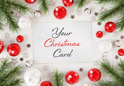 Christmas Card On White Surface  With  Ornaments Mockup