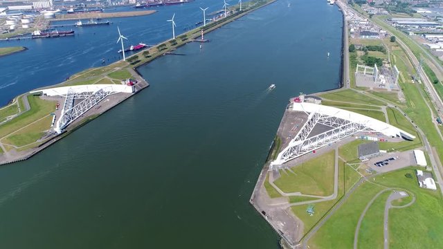Aerial bird view footage Maeslantkering storm surge barrier on Nieuwe Waterweg Netherlands it closes if the city of Rotterdam is threatened by floods and is one of largest moving structures on earth