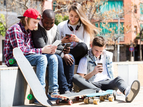 Happy Teens Playing On Smarthphones