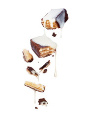 Waffle chocolate bar is poured over condensed milk on white background