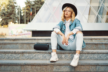 Fashionable modern woman with glasses in the city