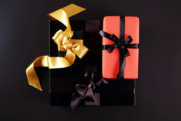 Beautiful minimalistic multi purpose composition with gift box wrapped and tied with satin ribbon. Holiday present in festive wrapping. Background, copy space, close up, top view, flat lay.