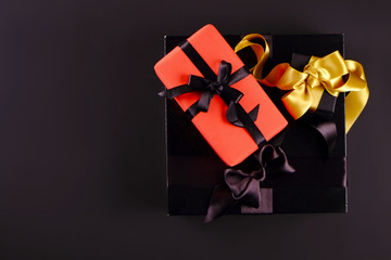 Beautiful minimalistic multi purpose composition with gift box wrapped and tied with satin ribbon. Holiday present in festive wrapping. Background, copy space, close up, top view, flat lay.