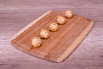 Tasty cheese balls served in the wooden plate