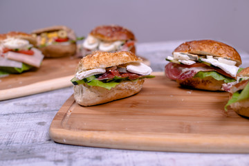 Mixed salad sandwiches with integral bread on wooden board