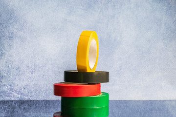 band of tapes of different colors on a gray background, copy space