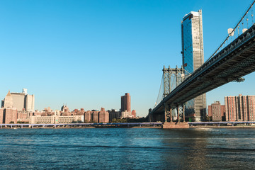 Manhattan Bridge over East River at the early morning sun light. The Bridge connects Lower Manhattan with Brooklyn of New York, USA.