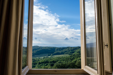 Panoramic view of the rolling hills of Chianti through a window in early morning