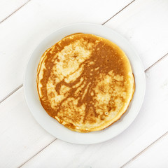 Round thin pancake on the plate