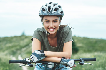 Mountain biking - woman with fatbike enjoys summer vacation. Close up