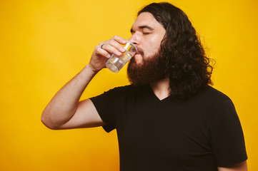 Bearded man drinks water