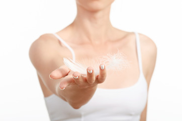 Beautiful woman in hands a feather beauty care body on white background isolation