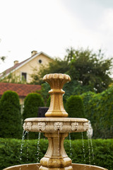 antique little waterfall in the garden falling drops close-up