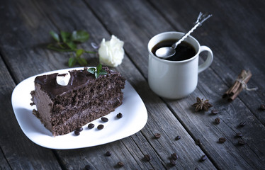 Delicious tasty cake and a cup of coffee on a wooden table