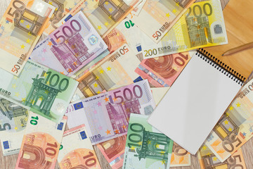 Euro, European money, various denominations a notebook in which you can write something.