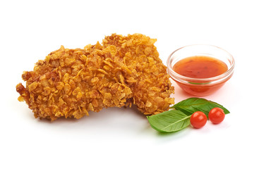 Fried Tasty Crispy Breaded Chicken Nuggets with basil leaves and spicy sauce, close-up, isolated on a white background.