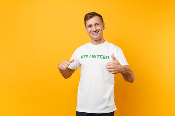 Portrait of happy smiling confident young man in white t-shirt with written inscription green title...