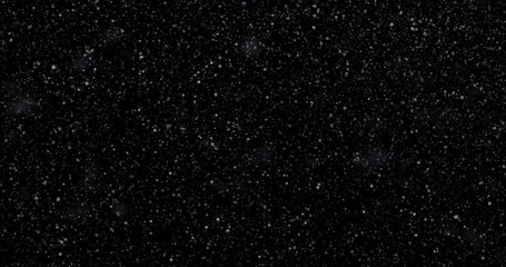 Natural white winter snowfall on a black background