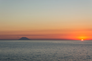 Naklejka na ściany i meble Sunset on Stromboli volcanic island view from Tropea in Calabria Italy