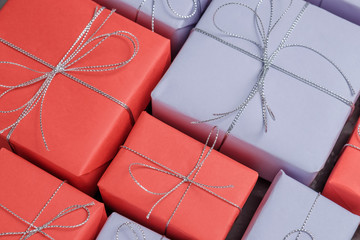 Lots of festive presents wrapped in red and lilac paper