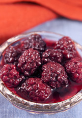 Blackberry in a glass bowl on the linen cloth