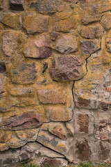 Anciend wall made of colorful rocks. Korela Fortress, Russia