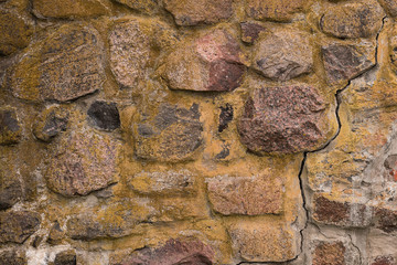 Anciend wall made of colorful rocks. Korela Fortress, Russia