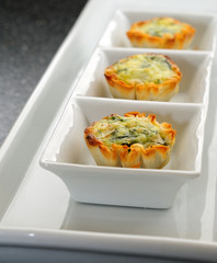 Mini Quiche Pies On A White Serving Plate Appetizers