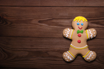 Gingerbread man on wooden background.