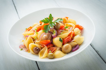 Dish of shell pasta with various vegetables 
